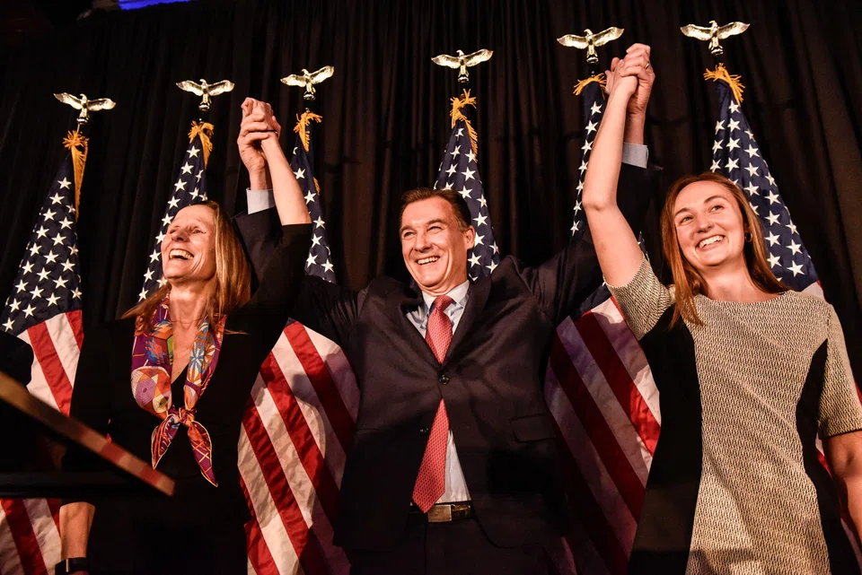 Democrat Tom Suozzi celebrates with his family after his victory in the special election to replace Republican Representative George Santos in Woodbury, New York, Feb 13, 2024. 