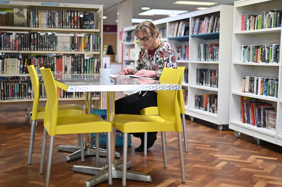 Marina Flynn sits in the cafe at Chantry Library in Ipswich, eastern England on Jan 26, 2023. The 54-year-old is unemployed and relies on the library’s food bank that provides donated staples and sanitary products for free.