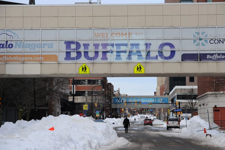 Pedestrians walk along Ellicott Street in downtown Buffalo, New York on Dec 28, 2022.