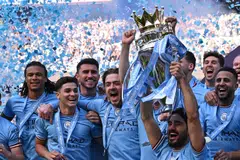 Manchester City's Ilkay Gundogan lifts the trophy as its players celebrate winning the title at the presentation ceremony following the English Premier League football match between Manchester City and Chelsea at the Etihad Stadium in Manchester, England, May 21, 2023. 