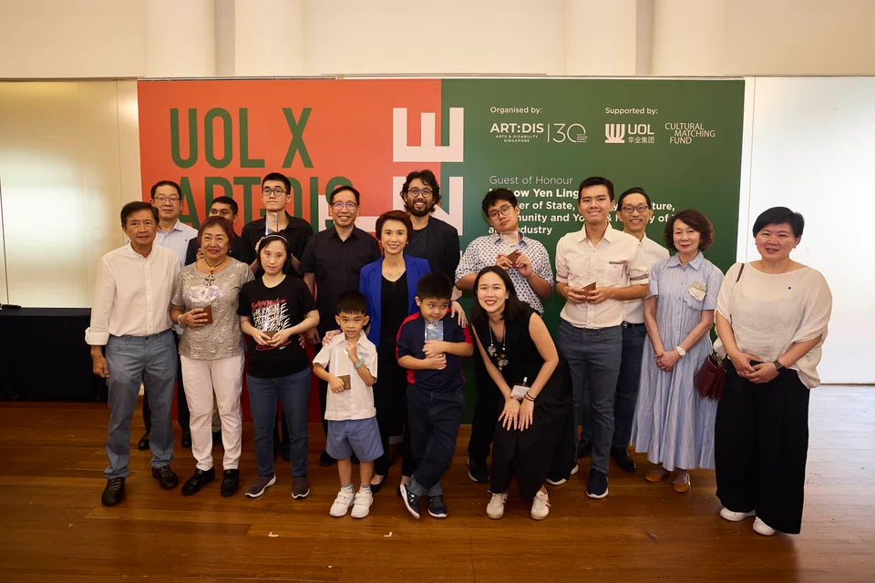 Guest of honour Low Yen Ling, Minister of State for Culture, Community and Youth (centre, in blue), with the winners and judges of the inaugural UOL X Art:Dis Art Prize.