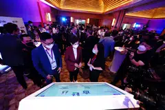 Minister for Communications and Information Josephine Teo (centre) with regional commercial manager of Advario Kelvin Ling (left) and SGTraDex Services head of market development Thaw Yee Leng (right) at the product demonstration for SGTraDex.