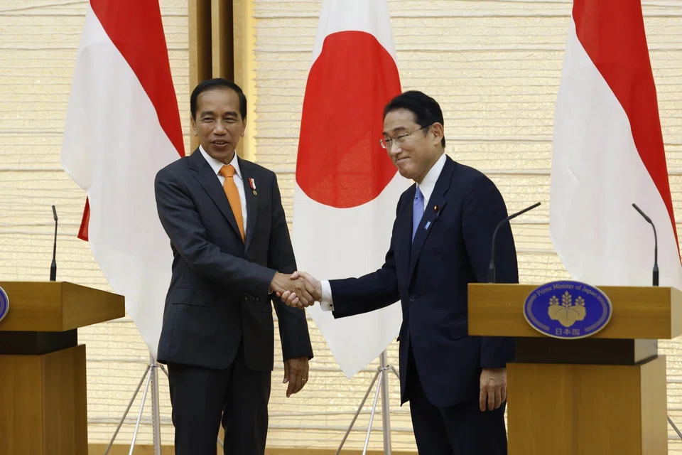 Indonesia's president Joko Widodo (left) shakes hands with Japan's prime minister Fumio Kishida (right) at the prime minister's official residence in Tokyo, Japan, July 27, 2022. 