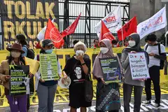 Activists holding a protest against the new criminal code outside Parliament building in Jakarta. The UN is concerned that several articles in the revised Criminal Code contravene Indonesia’s international legal obligations with respect to human rights.