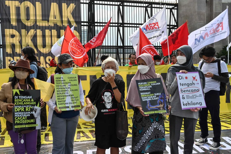 Activists holding a protest against the new criminal code outside Parliament building in Jakarta. The UN is concerned that several articles in the revised Criminal Code contravene Indonesia’s international legal obligations with respect to human rights.