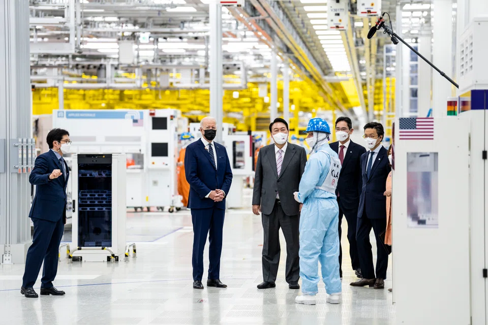 US President Joe Biden tours a semiconductor facility near Seoul. The electronics insourcing trend could intensify, with the US and China expanding domestic capacity, said MAS.