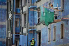 Men work at a construction site in Beijing, China. The slump in China property stocks has been a key driver of the recent market downturn, as traders feared a broader contagion from the ailing sector.
