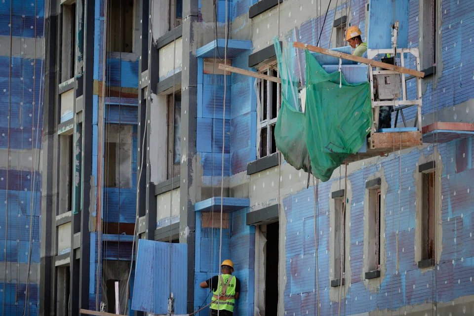 Men work at a construction site in Beijing, China. The slump in China property stocks has been a key driver of the recent market downturn, as traders feared a broader contagion from the ailing sector.