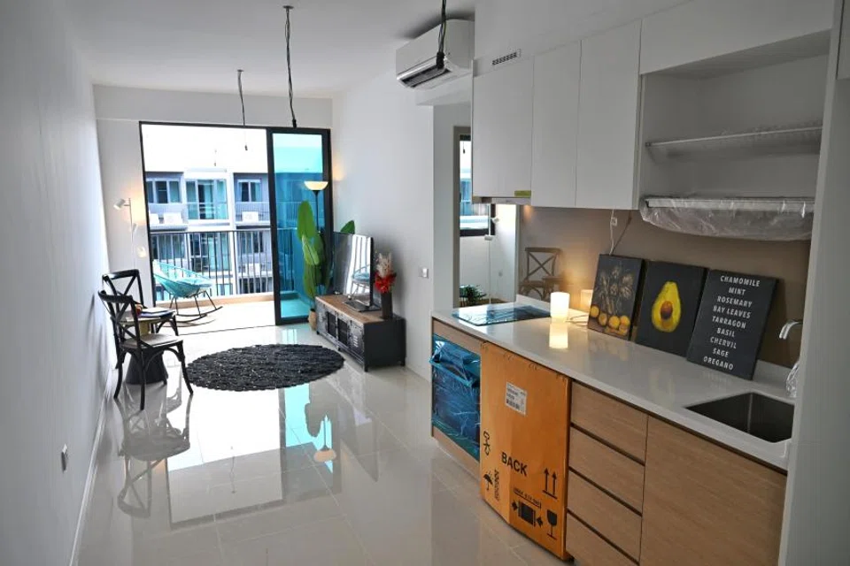 The kitchen and living room of a two-bedroom unit at the Treasure at Tampines condominium. 