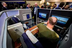 A visitor sits in a Lufthansa mock-up business class cabin at the International Tourism Trade Fair in Berlin, Germany, March 8, 2023. 