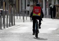 A Just Eat delivery man rides his bicycle in Nice, France.