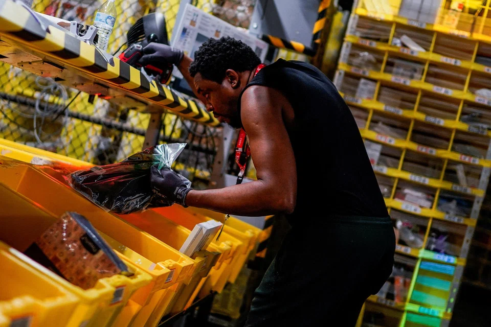 A worker selects and packs items during Cyber Monday at the Amazon fulfilment centre in New Jersey. Heavy online traffic and transactions could add up to a record US$12 billion outlay by US shoppers on Cyber Monday.