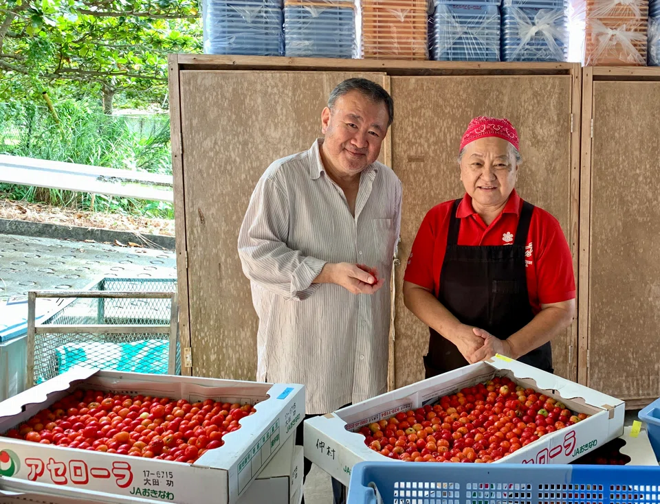 Tetsuya Wakuda learns about acerola cherries from farmer Tetsuko Namisato.