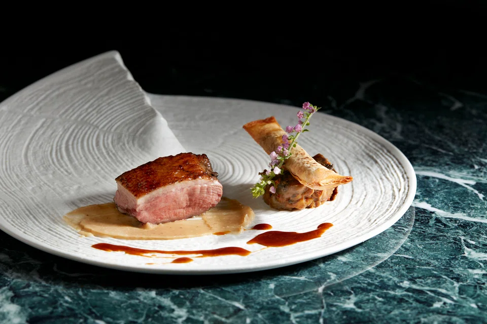 Duck breast with spring roll cigar, chanterelle mushrooms and chestnuts.