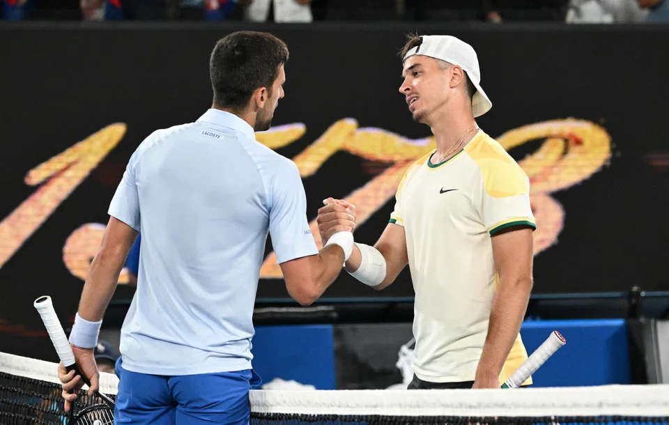 Novak Djokovic (left) shaking hands with Dino Prizmic after defeating him in their first round match.