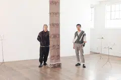 Young Chung, left, and Kibum Kim, owners of Commonwealth and Council gallery in Los Angeles, next to work by Carmen Argote and Jesse Chun.