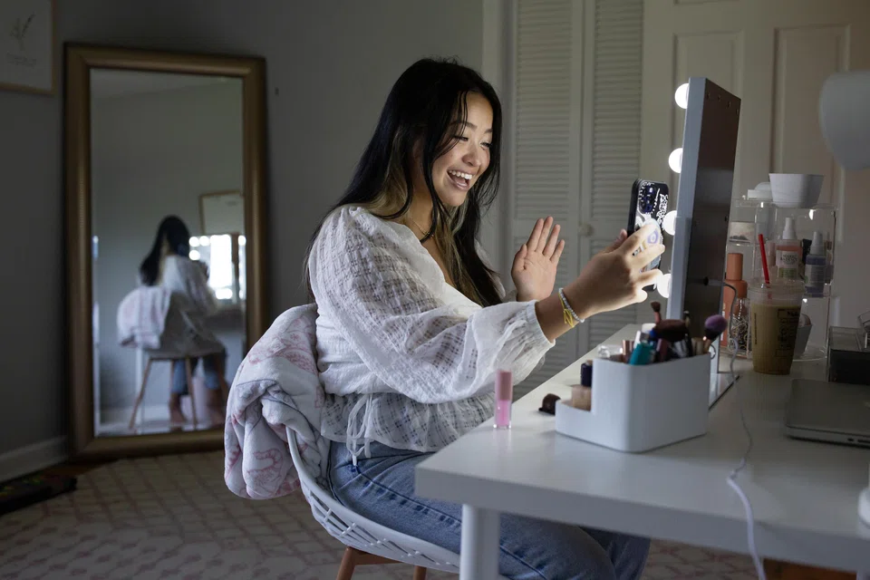 Maddi Koch, who has three million followers on TikTok, practising for a video.  Koch, who is sometimes paid by film companies to promote their work, says that she makes videos to connect people and to spare them 'the pain of arguing over finding a movie or not knowing what you’re really looking for'.