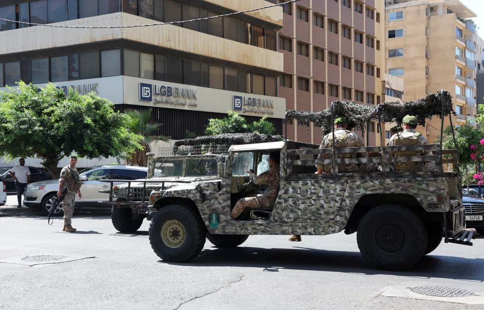 Lebanese army soldiers deploy outside an LGB Bank branch, where an armed man entered the branch seeking access to his own savings, according to a bank employee, in Ramlet al-Bayda area in Beirut.