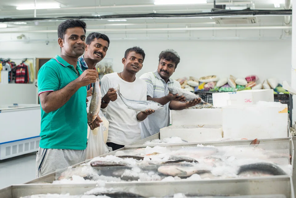 Foreign worker residents at the supermarket housed within the Westlite accommodation.