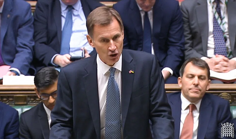 A video grab from footage broadcast by the UK Parliament, showing Britain's Chancellor of the Exchequer (finance minister) Jeremy Hunt making an autumn budget statement in the House of Commons in London on Thursday (Nov 17). 