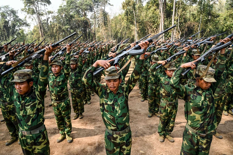Members of the ethnic rebel group Ta'ang National Liberation Army (TNLA) take part in a training exercise at their base camp in the forest in Myanmar's northern Shan State. Along with two other armed groups, they claim to have seized dozens of military outposts and blocked vital trade routes to China.