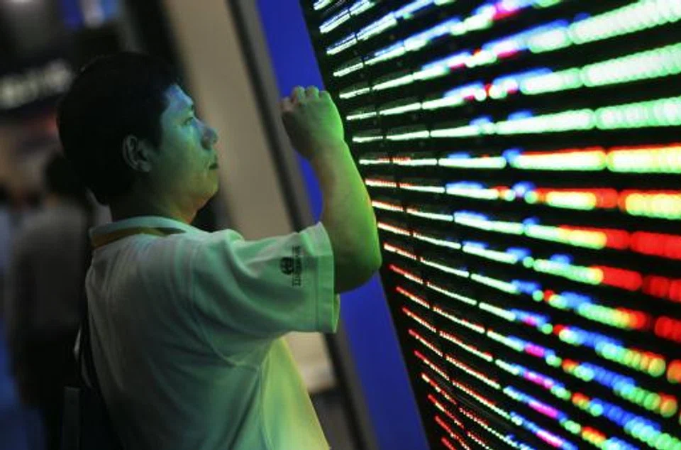 A visitor inspects an energy-efficient LED panel's construction at the LED (Light-Emitting Diodes) exhibition in Taipei, Taiwan. 