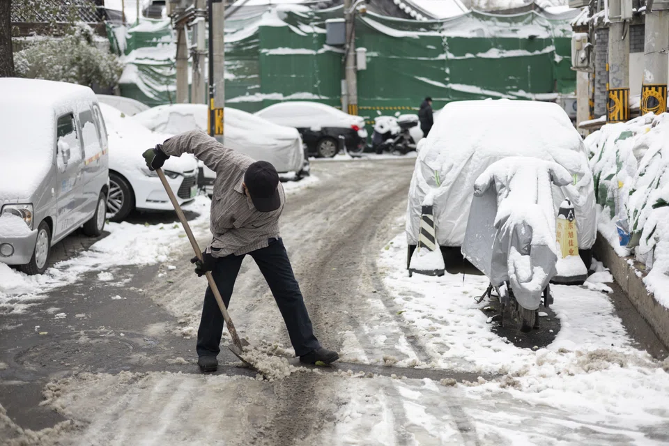 A man shovels snow on a street in Beijing, China, Dec 11 2023. 