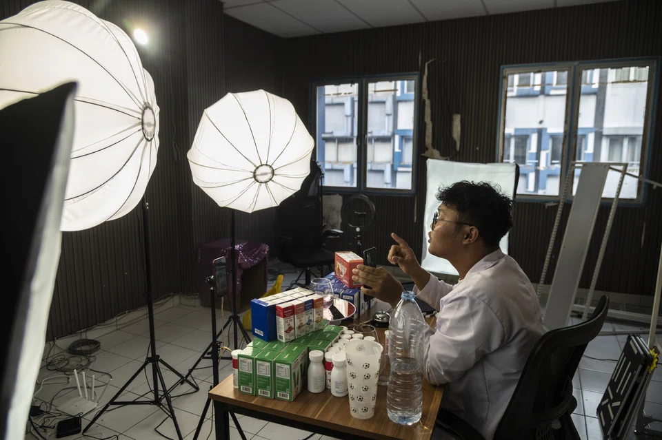 At his studio in Jakarta, Flame Media's Hank Wang directs his team to sell products on behalf of cosmetics and consumer goods makers such as L’Oreal, earning a cut and sharing the profits with the livestreaming hosts. 