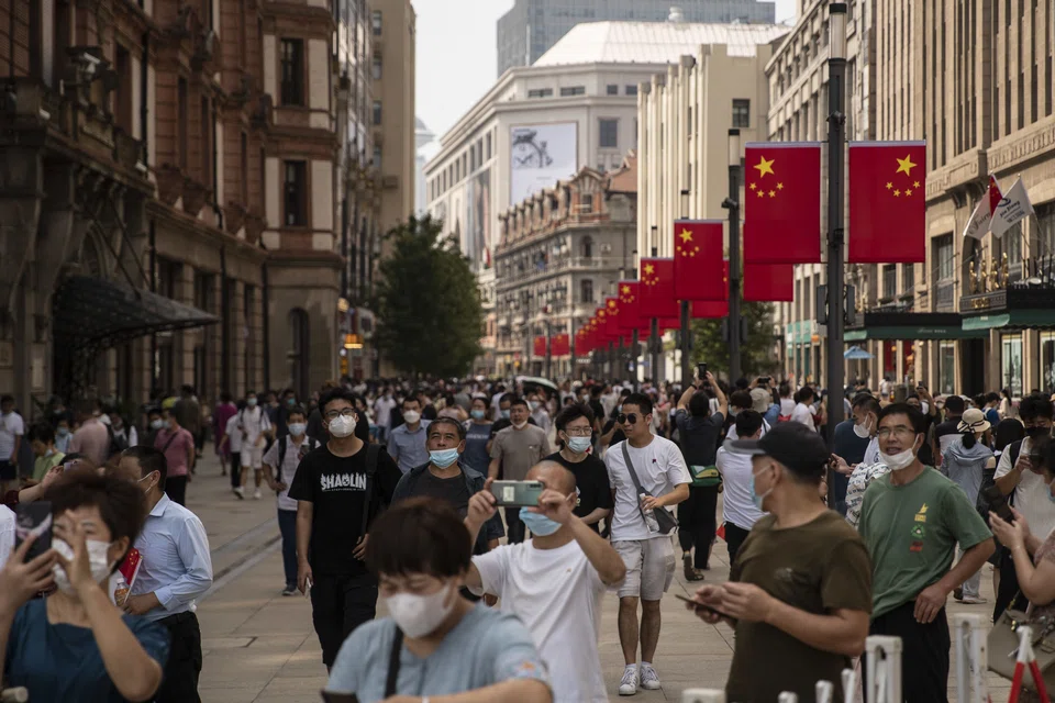 Pedestrian traffic along Nanjing Road in Shanghai on Oct 2.  Policymakers have rolled out a flurry of measures to bolster the world’s second-largest economy, which narrowly escaped a contraction in the second quarter, as stringent Covid curbs and a deepening property slump weigh on the outlook.