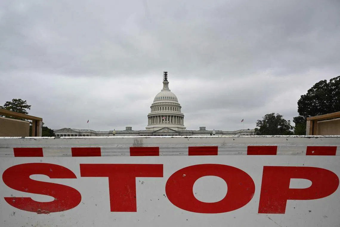 A traffic barrier is seen front of the dome of the US Capitol as a government shutdown looms in Washington, DC on Sept 28, 2023. 