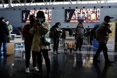 Travellers at Beijing Capital International Airport in Beijing, China, Dec 27, 2022. Online searches for flights abroad surged after Beijing said it would scrap mandatory quarantine for overseas arrivals, state media reported.