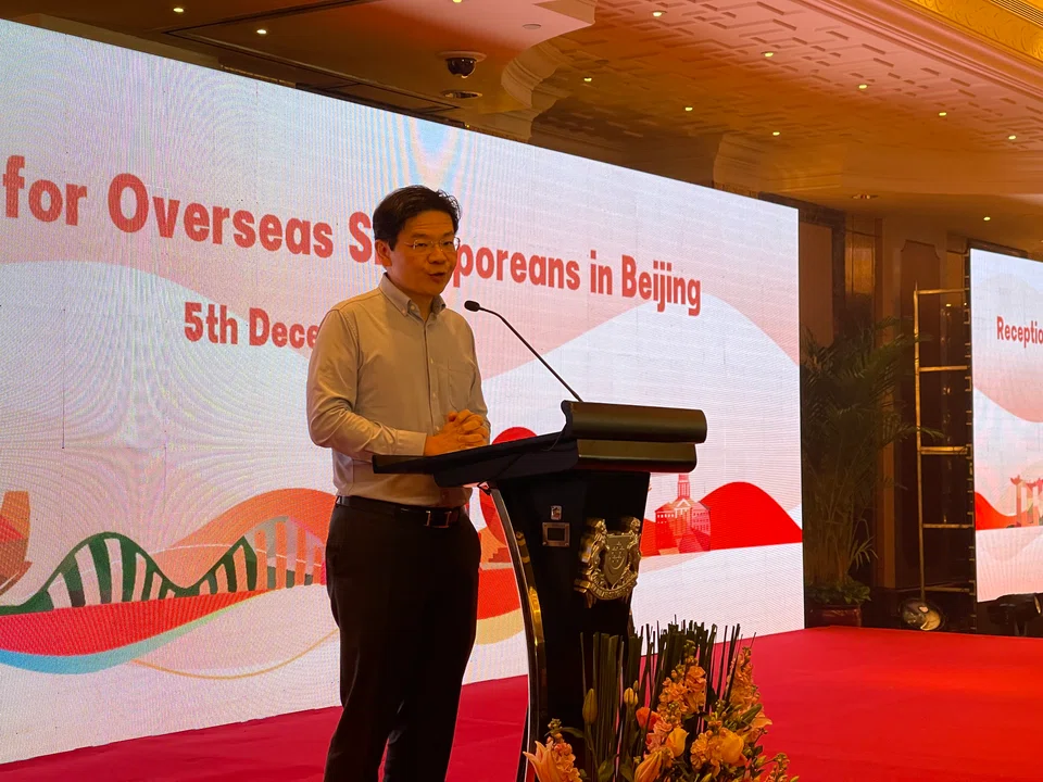 DPM Lawrence Wong addressing a group of 300 overseas Singaporeans at a reception in Beijing on Tuesday.