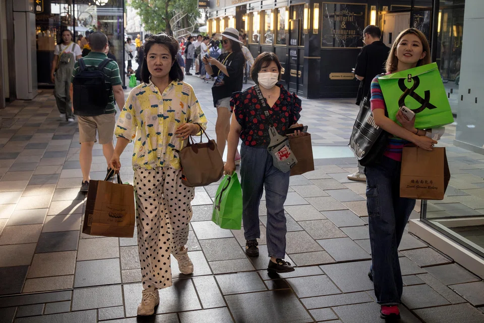 Women in a shopping district in Beijing. Many young Chinese women cite high childcare costs, a disrupted career and not wanting to get married as the main reasons for not wanting children. China's population dipped for the first time in 60 years in 2022. 