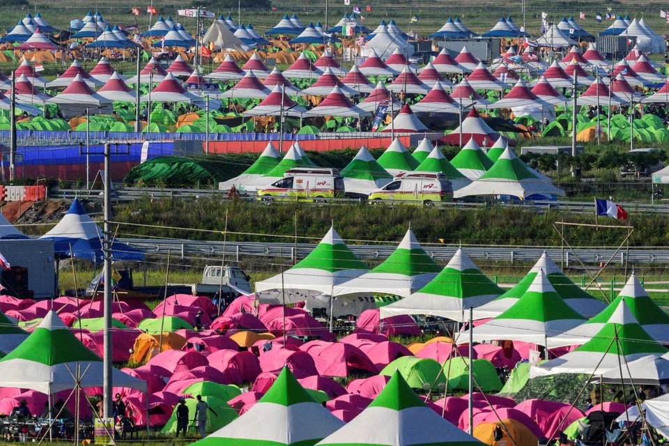 Ambulances leaving the campsite of the World Scout Jamboree on Saturday (Aug 5); hundreds of participants have fallen ill due to the searing heat, prompting complaints from parents over the safety of their children. 