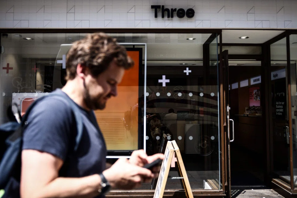 A Three mobile phone shop in London. Hong Kong-based CK Hutchison said in a filing that net profit in the first half declined to HK$11.2 billion on a post-IFRS 16 basis.