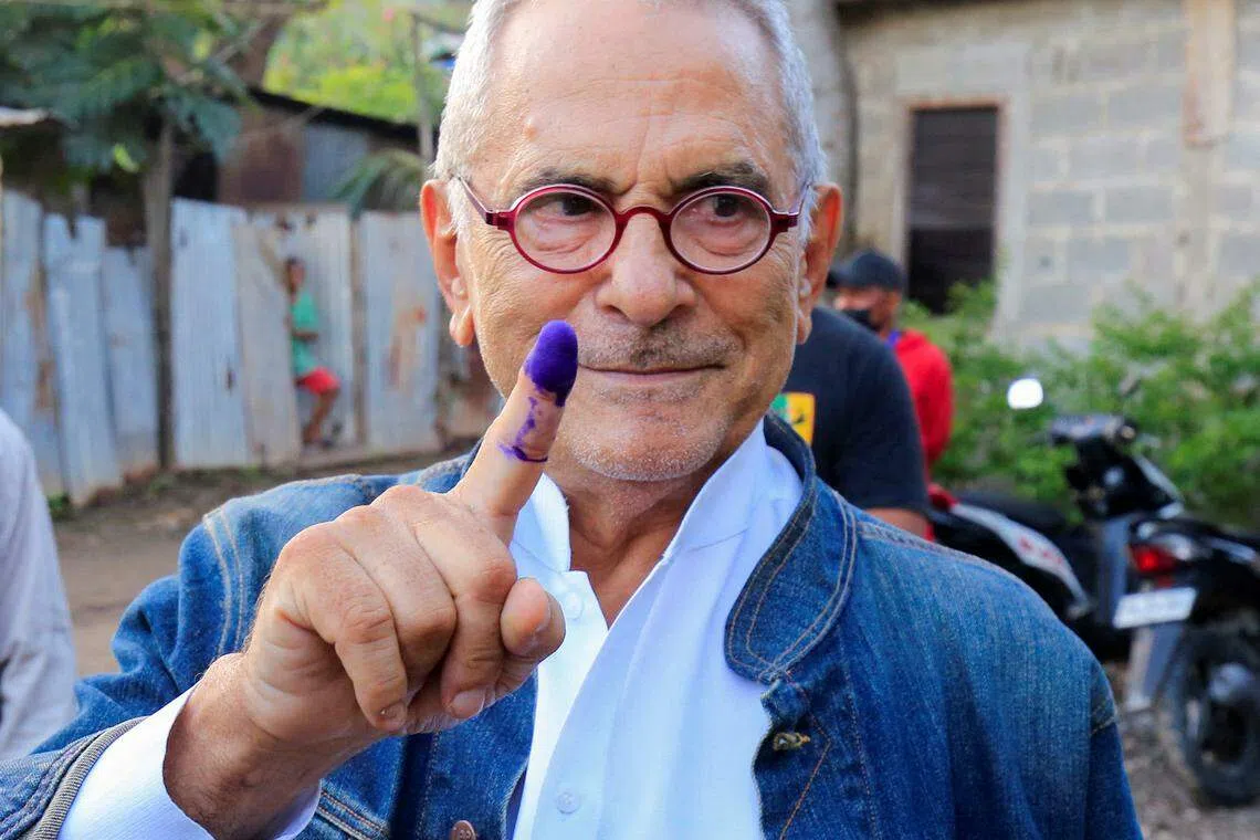 East Timor presidential candidate Jose Ramos Horta shows his inked finger after casting his ballot during the second round of East Timor's presidential election in Dili, East Timor, April 19, 2022. 