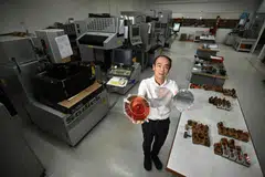 Chee Teck Lee, CEO of Moveon Technologies, holding wafer level optics at Moveon’s manufacturing facility.
