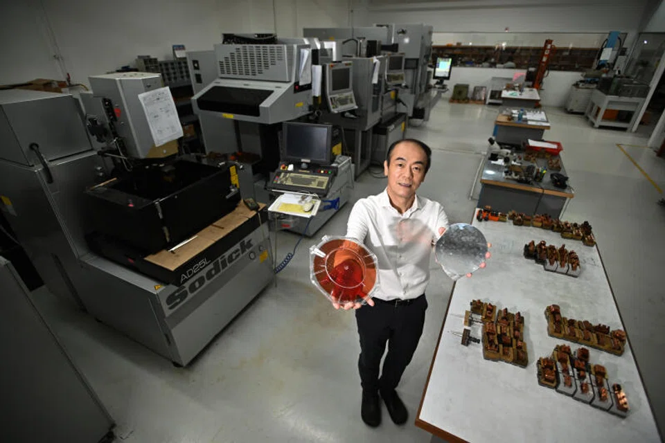 Chee Teck Lee, CEO of Moveon Technologies, holding wafer level optics at Moveon’s manufacturing facility.