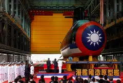 A bottle is broken against the hull of Narwhal, Taiwan's first domestically built submarine, as President Tsai Ing-wen attends the submarine's launching ceremony in Kaohsiung.