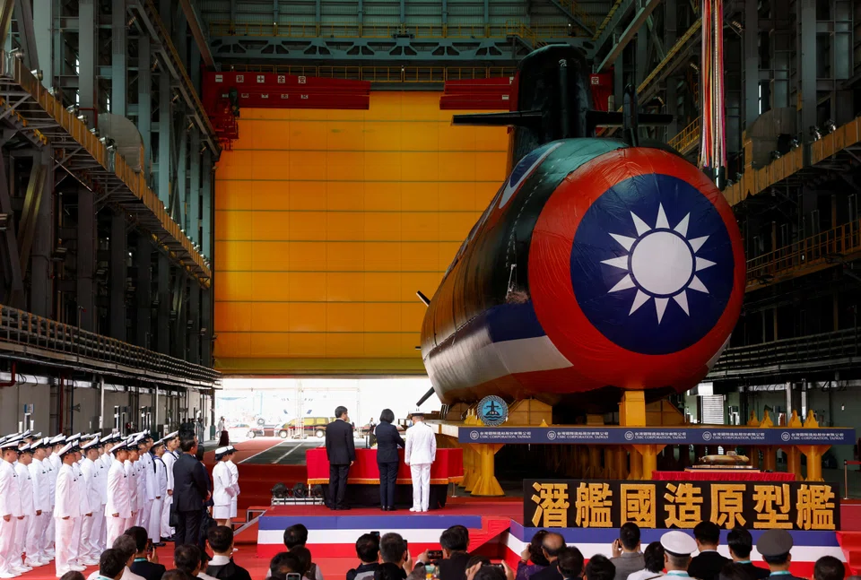 A bottle is broken against the hull of Narwhal, Taiwan's first domestically built submarine, as President Tsai Ing-wen attends the submarine's launching ceremony in Kaohsiung.