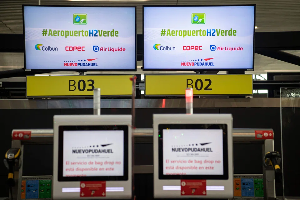 Screens promoting the use of green hydrogen at an airport in Santiago. Major oil companies still spend the bulk of their money on oil and gas, but are devoting a growing proportion to low-carbon energy.