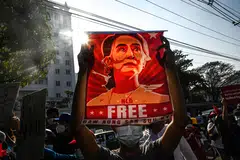 A protester holds up a poster of Aung San Suu Kyi during a demonstration against the military coup in Yangon, Myanmar, Feb 15, 2021. Observers say planned polls by the junta cannot be free and fair under the present circumstances, with one analyst characterising it as a mere “performance” aimed at justifying the military’s hold on power.
