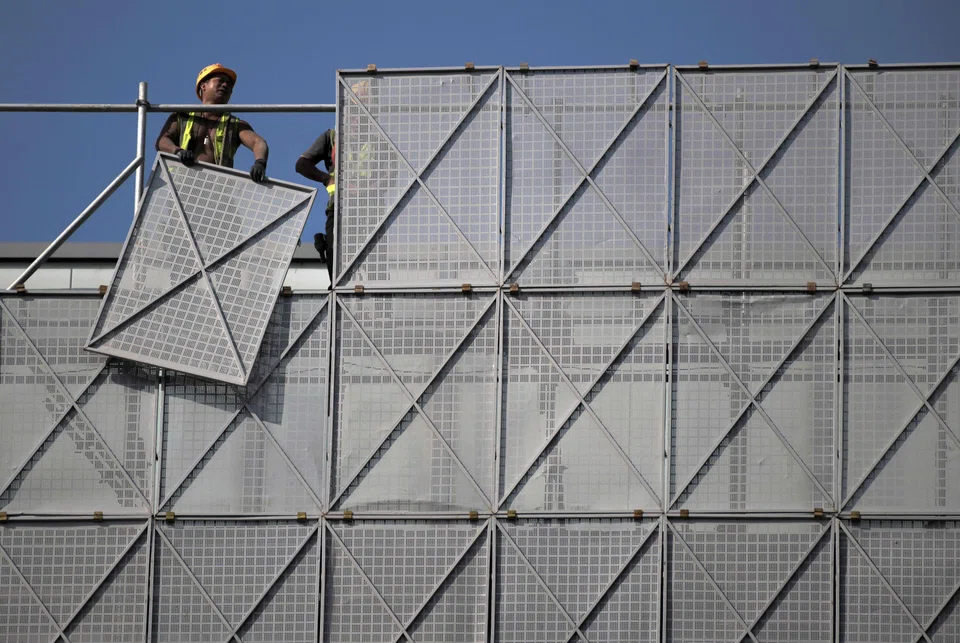 Construction workers at a site in Beijing. China’s home sales have fallen for more than a year, squeezing a key source of property firms’ liquidity and leading to rising defaults on everything from public debt and bank loans to trust borrowings for property projects. 