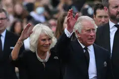 Britain's King Charles III and Britain's Camilla, Queen Consort wave as they greet the crowd upon their arrival at Buckingham Palace in London, on Sep 9, 2022, a day after Queen Elizabeth II died at the age of 96. 