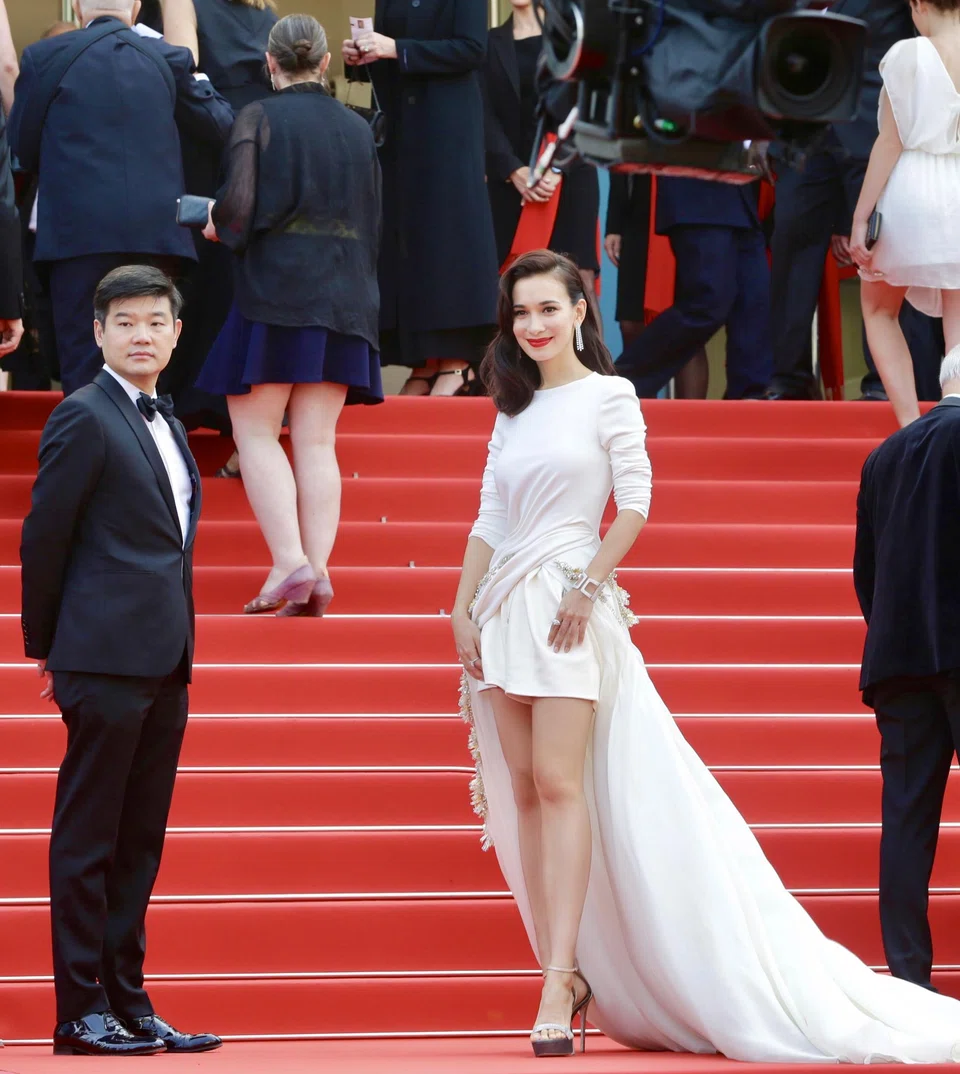 Longtime talent manager Andrew Ooi with actress Celina Jade on the red carpet.
