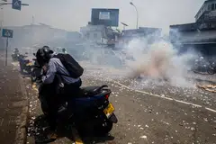 Supporters of President Ranil Wickremesinghe light firecrackers after the IMF's approval of a US$3 billion bailout package.