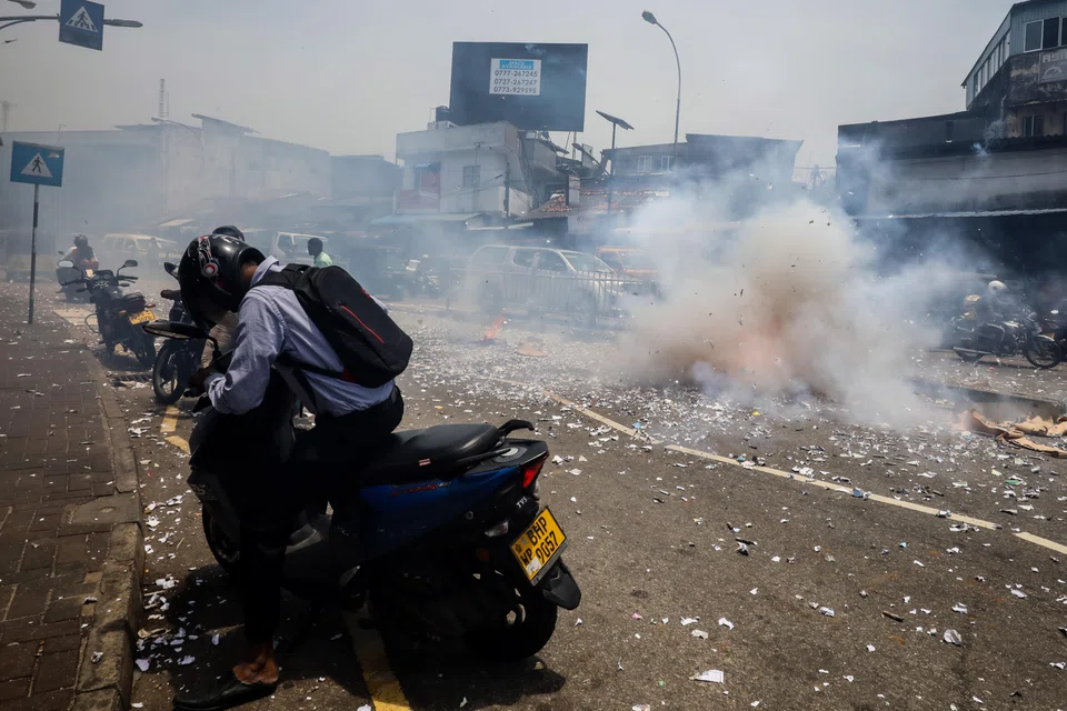 Supporters of President Ranil Wickremesinghe light firecrackers after the IMF's approval of a US$3 billion bailout package.