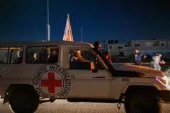 An International Red Cross vehicle reportedly carrying hostages released by Hamas crosses the Rafah border point in the Gaza Strip towards Egypt from where they would be flown to Israel to be reunited with their families.