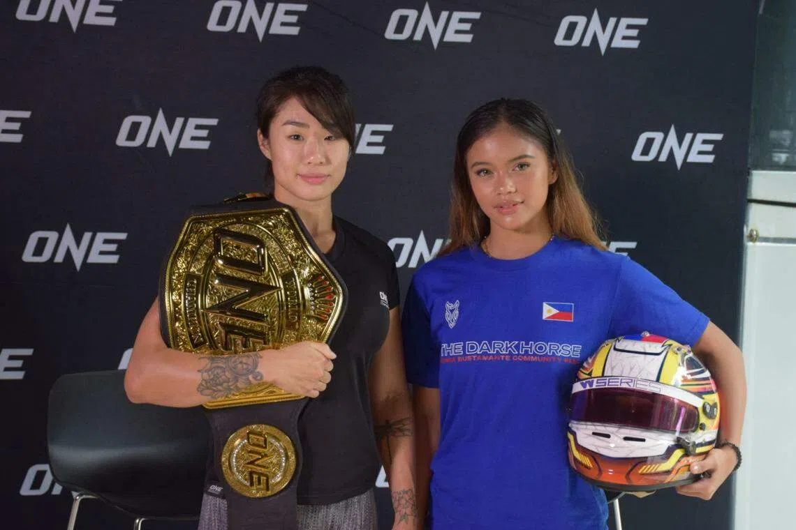 One Championship women's atomweight world champion Angela Lee (left) together with Filipino race driver Bianca Bustamante at the Evolve MMA gym at Far East Square in Singapore. 