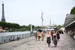 Chanel’s models paraded alongside the River Seine with the Eiffel Tower in the background. 